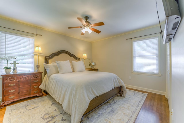 4834 Welchshire Ave, Memphis, TN 38117 - bedroom featuring wood finished floors, baseboards, ornamental molding, ceiling fan, and a wall unit AC