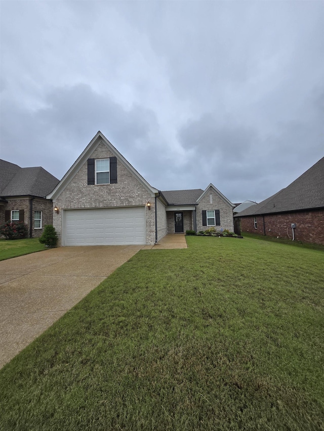 7898 Park Valley Dr, Southaven, MS 38671 - view of front of house with concrete driveway, a front lawn, and brick siding