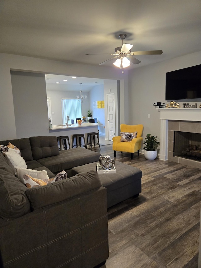 7898 Park Valley Dr, Southaven, MS 38671 - living area with wood finished floors, a chandelier, ceiling fan, baseboards, and a tiled fireplace