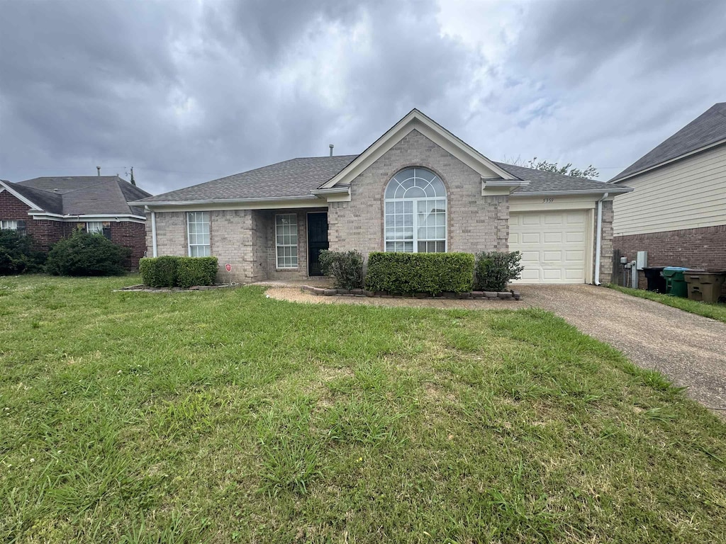 5359 Farm Ridge Dr, Memphis, TN 38141 - ranch-style home with asphalt driveway, an attached garage, brick siding, a front yard, and roof with shingles