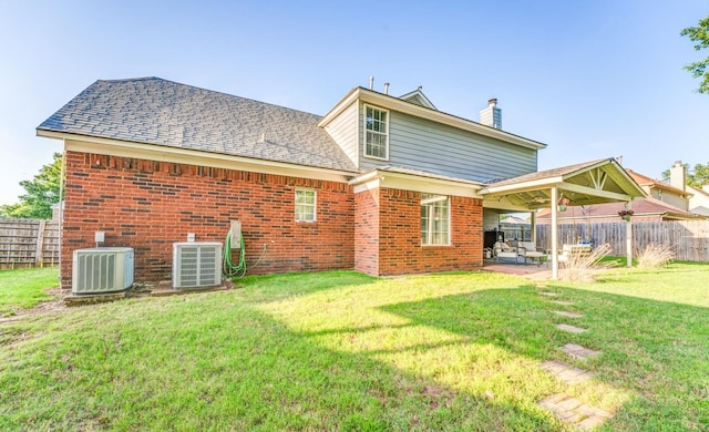 8023 Allbright Cv, Bartlett, TN 38133 - rear view of house with central air condition unit, a patio area, a chimney, and brick siding