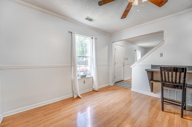 8023 Allbright Cv, Bartlett, TN 38133 - foyer entrance featuring light wood-style flooring, ceiling fan, ornamental molding, a textured ceiling, and baseboards