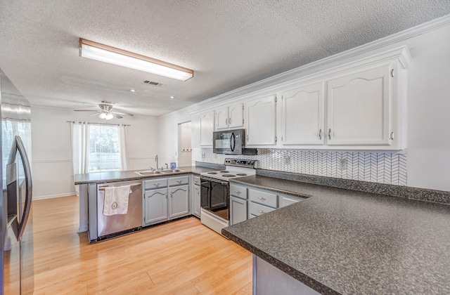 8023 Allbright Cv, Bartlett, TN 38133 - kitchen with stainless steel appliances, a peninsula, dark countertops, a sink, and tasteful backsplash