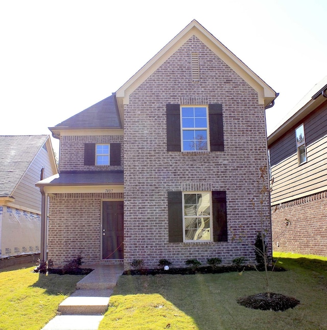 7407 Crayton Ridge Dr, Cordova, TN 38018 - traditional-style home featuring brick siding and a front lawn
