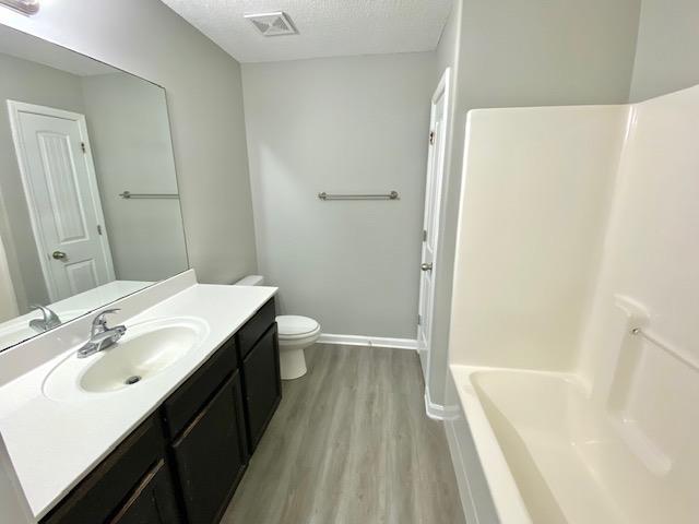 7407 Crayton Ridge Dr, Cordova, TN 38018 - full bath featuring vanity, wood finished floors, toilet, and baseboards