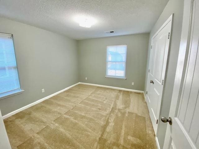 7407 Crayton Ridge Dr, Cordova, TN 38018 - unfurnished bedroom with a textured ceiling, light colored carpet, and baseboards