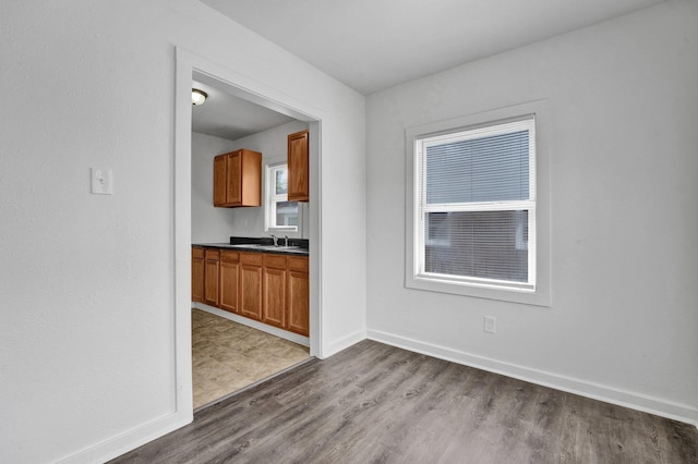 1394 Chadwick Cir, Memphis, TN 38114 - kitchen featuring brown cabinets, dark wood-type flooring, baseboards, and dark countertops