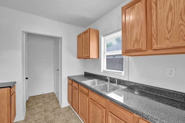 1394 Chadwick Cir, Memphis, TN 38114 - kitchen featuring a sink, dark countertops, and baseboards