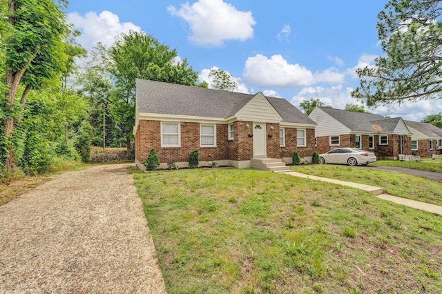 1394 Chadwick Cir, Memphis, TN 38114 - view of front of property with concrete driveway, brick siding, a front lawn, and a shingled roof