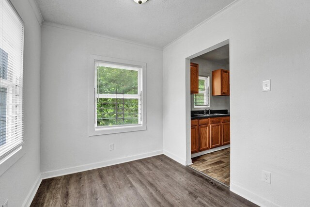 1394 Chadwick Cir, Memphis, TN 38114 - unfurnished dining area featuring crown molding, dark wood finished floors, a sink, and baseboards
