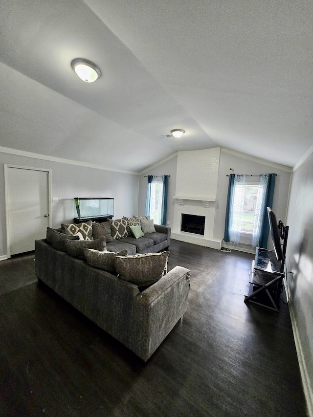 3393 Brownbark Dr, Memphis, TN 38115 - living area featuring vaulted ceiling, plenty of natural light, a fireplace with raised hearth, and wood finished floors