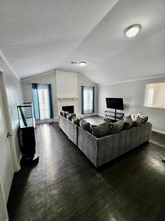 3393 Brownbark Dr, Memphis, TN 38115 - living area featuring lofted ceiling, a fireplace, wood finished floors, baseboards, and plenty of natural light