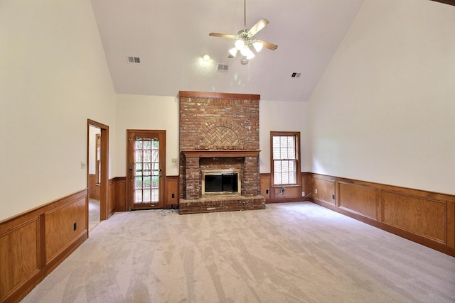 791 Autumn Winds Dr, Collierville, TN 38017 - unfurnished living room with high vaulted ceiling, a wainscoted wall, light carpet, a ceiling fan, and a fireplace