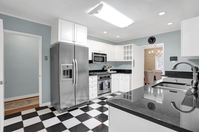 4141 Sequoia Ave, Memphis, TN 38117 - kitchen with stainless steel appliances, a sink, dark flooring, a chandelier, and white cabinetry