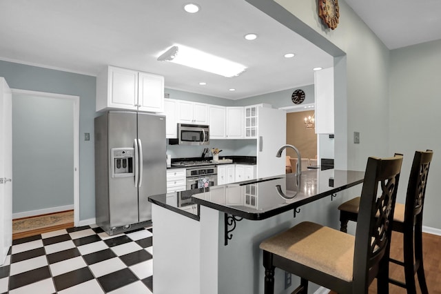 4141 Sequoia Ave, Memphis, TN 38117 - kitchen with appliances with stainless steel finishes, a sink, dark countertops, a peninsula, and dark floors