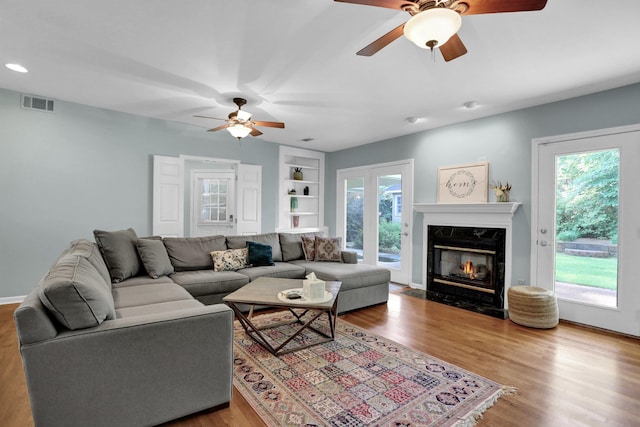 4141 Sequoia Ave, Memphis, TN 38117 - living area featuring ceiling fan, built in features, wood finished floors, a fireplace, and recessed lighting