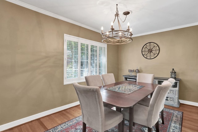 4141 Sequoia Ave, Memphis, TN 38117 - dining space with baseboards, a chandelier, wood finished floors, and crown molding