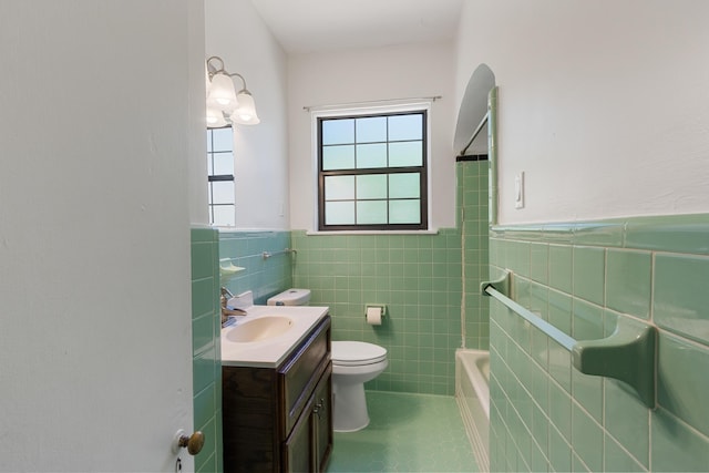 1021 N Barksdale St, Memphis, TN 38107 - bathroom with tile walls, vanity, wainscoting, toilet, and tile patterned floors
