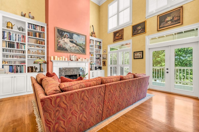 182 Harbor Isle Cir, Memphis, TN 38103 - living room featuring a premium fireplace, light wood-type flooring, a towering ceiling, and built in features