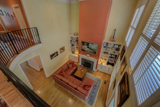 182 Harbor Isle Cir, Memphis, TN 38103 - living area with a high ceiling, wood finished floors, a fireplace, baseboards, and stairway