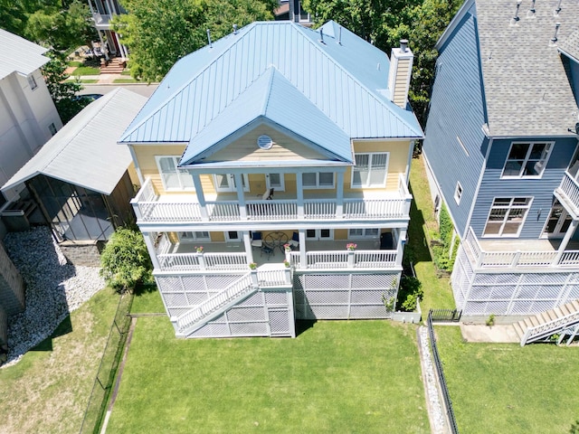 182 Harbor Isle Cir, Memphis, TN 38103 - back of house featuring a chimney, a balcony, a lawn, and metal roof