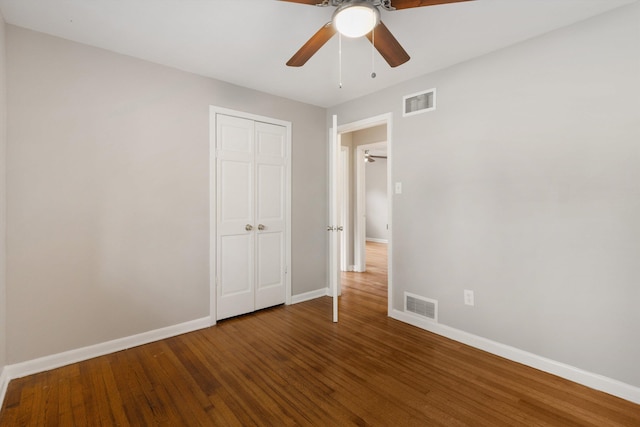 307 Melita Rd, Memphis, TN 38120 - unfurnished bedroom with baseboards, wood finished floors, a closet, and a ceiling fan
