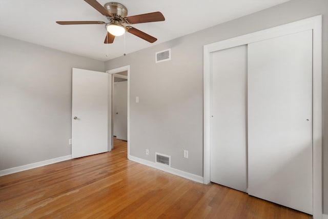 307 Melita Rd, Memphis, TN 38120 - unfurnished bedroom with light wood-style floors, baseboards, a closet, and a ceiling fan