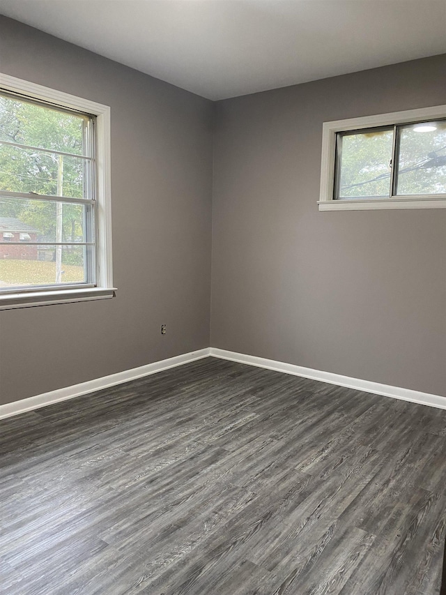 4219 Coventry Ave, Memphis, TN 38127 - empty room with dark wood finished floors, plenty of natural light, and baseboards