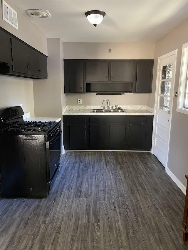 4219 Coventry Ave, Memphis, TN 38127 - kitchen featuring black gas range, a sink, dark cabinetry, and dark wood-style floors