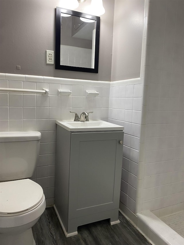 4219 Coventry Ave, Memphis, TN 38127 - bathroom featuring tile walls, wood finished floors, toilet, tiled shower, and vanity