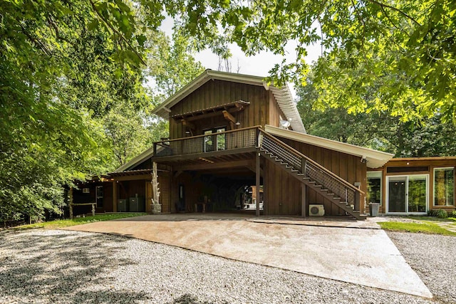1940 Nuckolls Rd, Rossville, TN 38066 - view of front of property featuring driveway, stairs, board and batten siding, a wooden deck, and a carport