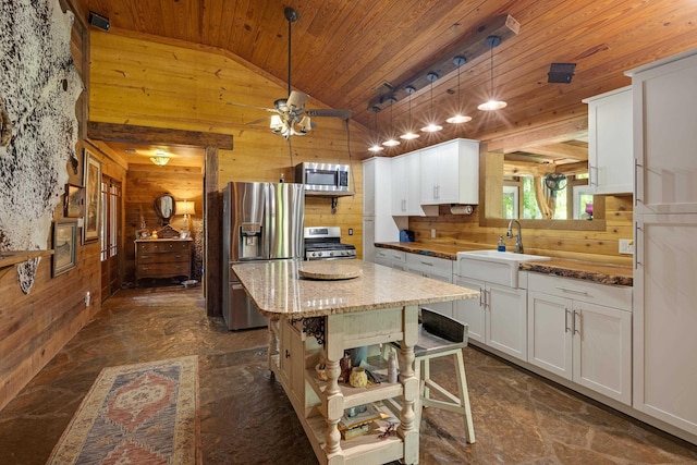 1940 Nuckolls Rd, Rossville, TN 38066 - kitchen featuring appliances with stainless steel finishes, wood ceiling, wooden walls, a sink, and lofted ceiling