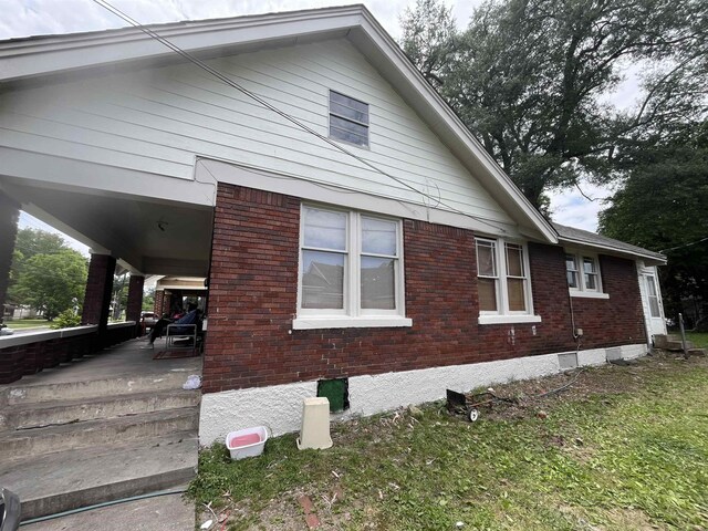 801 Spring St, Memphis, TN 38112 - view of property exterior featuring brick siding and a porch