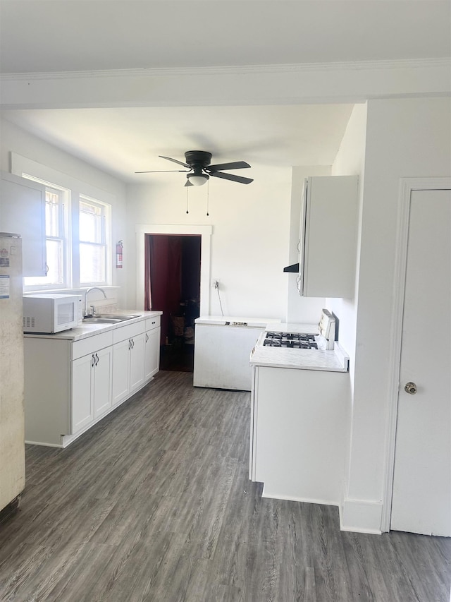801 Spring St, Memphis, TN 38112 - kitchen with white microwave, a sink, range, ceiling fan, and dark wood finished floors