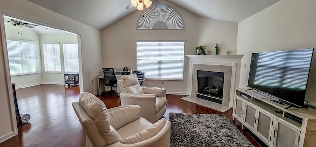 1601 E Southfield Cir, Memphis, TN 38016 - living room featuring a ceiling fan, dark wood-style floors, a tile fireplace, vaulted ceiling, and plenty of natural light