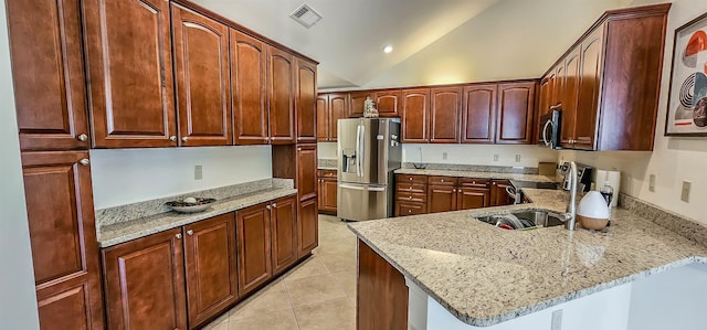 1601 E Southfield Cir, Memphis, TN 38016 - kitchen with stainless steel appliances, light tile patterned flooring, a sink, lofted ceiling, and a peninsula