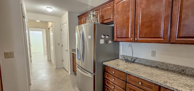 1601 E Southfield Cir, Memphis, TN 38016 - kitchen featuring stainless steel fridge, light tile patterned floors, and light stone countertops