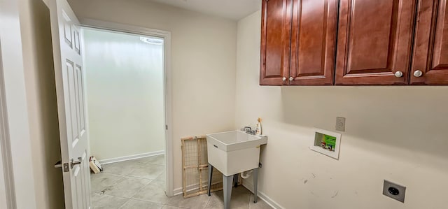 1601 E Southfield Cir, Memphis, TN 38016 - laundry room with electric dryer hookup, cabinet space, washer hookup, light tile patterned floors, and baseboards