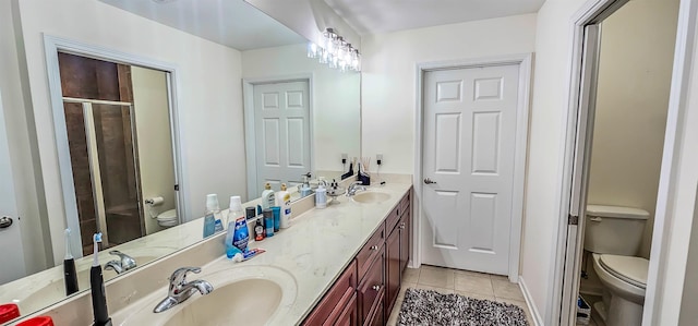 1601 E Southfield Cir, Memphis, TN 38016 - bathroom featuring toilet, tile patterned floors, double vanity, and a shower stall