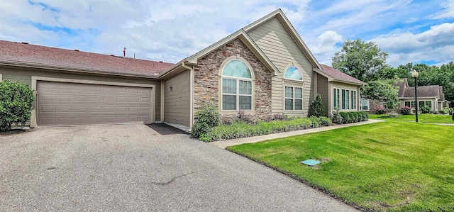 1601 E Southfield Cir, Memphis, TN 38016 - ranch-style house with driveway, stone siding, a garage, and a front yard
