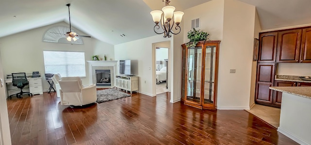 1601 E Southfield Cir, Memphis, TN 38016 - living area with a ceiling fan, dark wood-type flooring, lofted ceiling, a tiled fireplace, and a chandelier