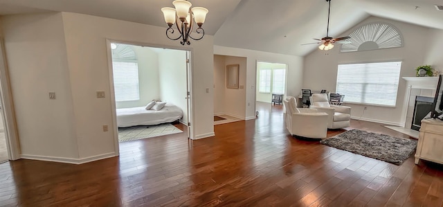 1601 E Southfield Cir, Memphis, TN 38016 - living area featuring dark wood finished floors, ceiling fan, baseboards, vaulted ceiling, and a chandelier