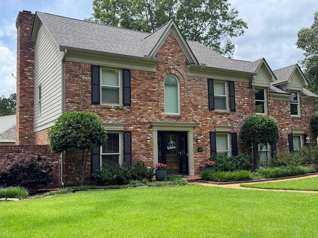 9290 E Bridge Dr, Germantown, TN 38139 - view of front of home featuring a chimney, a front yard, brick siding, and roof with shingles