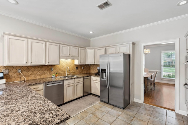 2045 Gallina Cir, Collierville, TN 38017 - kitchen featuring stainless steel appliances, tasteful backsplash, light tile patterned floors, ornamental molding, and dark stone counters