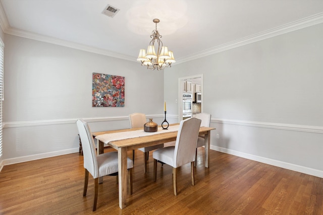 2045 Gallina Cir, Collierville, TN 38017 - dining room featuring a chandelier, wood finished floors, and crown molding