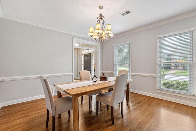 2045 Gallina Cir, Collierville, TN 38017 - dining area featuring a chandelier, crown molding, and wood finished floors