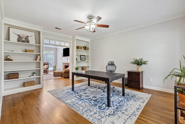 2045 Gallina Cir, Collierville, TN 38017 - home office with ornamental molding, ceiling fan, wood finished floors, built in features, and a fireplace