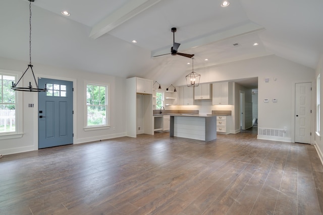 404 Williford Pl, Memphis, TN 38112 - unfurnished living room with a chandelier, a ceiling fan, healthy amount of natural light, baseboards, and recessed lighting