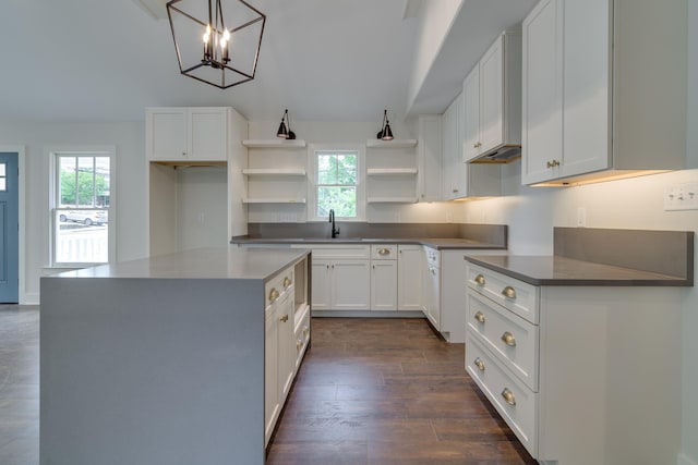 404 Williford Pl, Memphis, TN 38112 - kitchen featuring open shelves, dark wood finished floors, a sink, white cabinets, and a center island