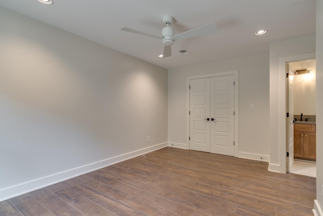 404 Williford Pl, Memphis, TN 38112 - unfurnished bedroom featuring baseboards, dark wood-type flooring, a sink, recessed lighting, and a closet